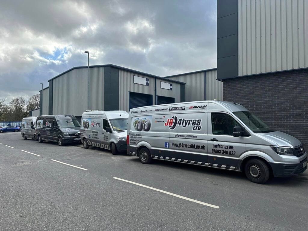 Group of JB4 Tyres work vans parked outside Clitheroe headquarters location.