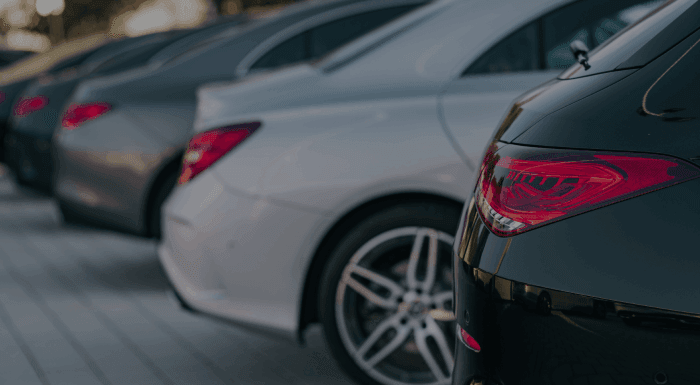 Row of cars parked in parking bay.